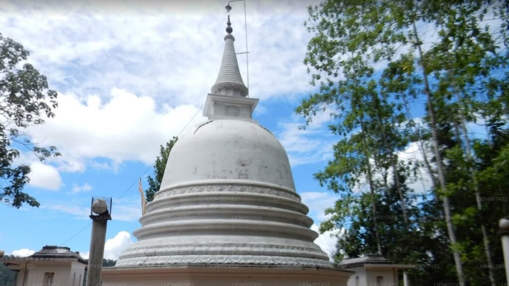Close-up detail of a pristine white Buddhist stupa (dagoba) at Elamaldeniya, showcasing its elegant architectural curves and golden pinnacle.
